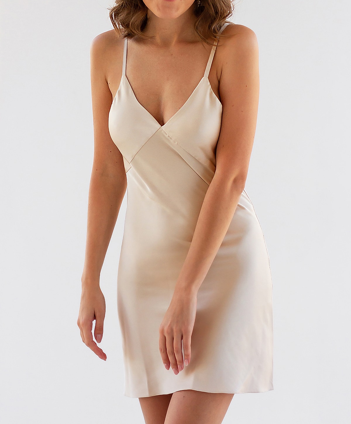 Model wearing a silky beige slip dress.