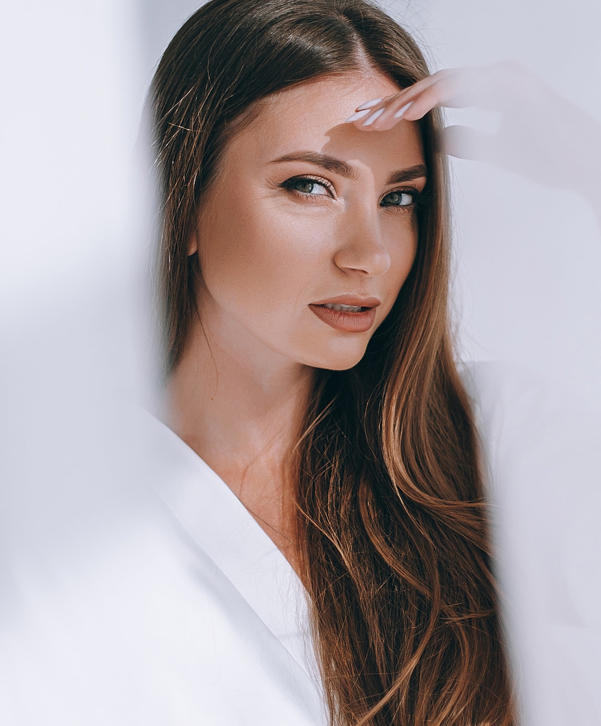 Young woman with long hair and soft expression.