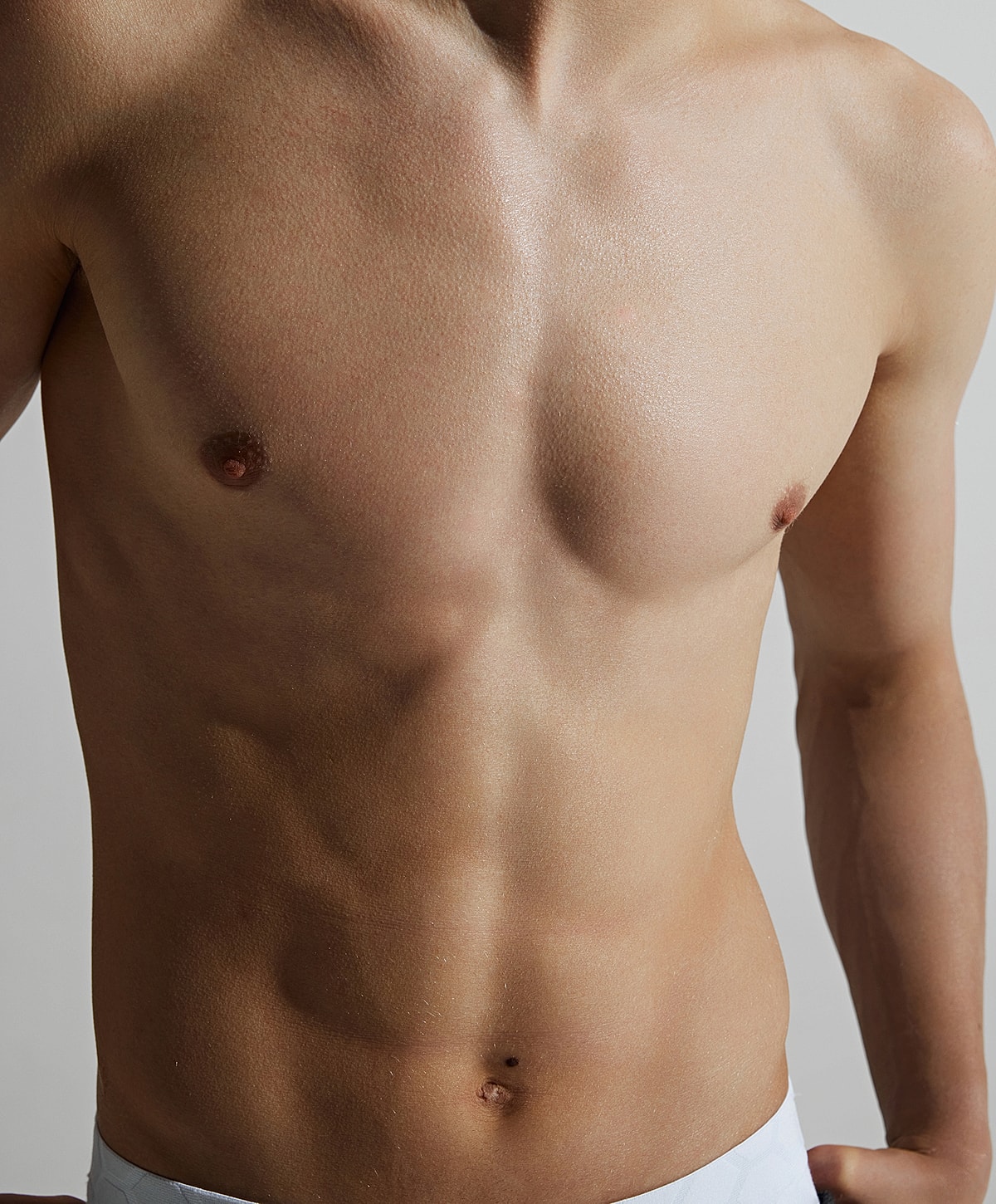 Male torso with defined muscles and smooth skin.