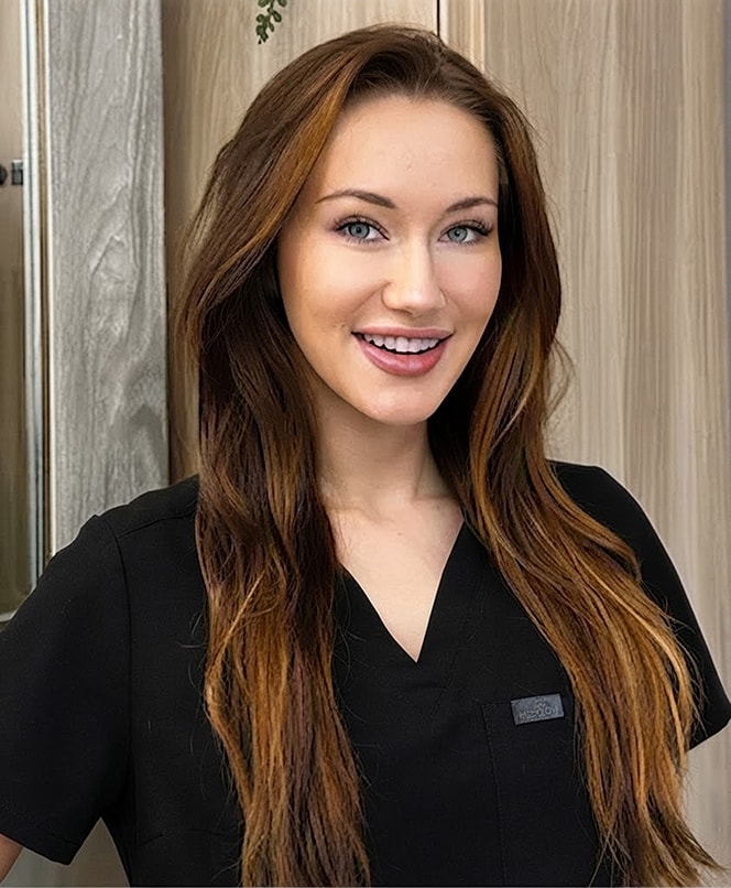 Smiling woman in a black medical uniform.