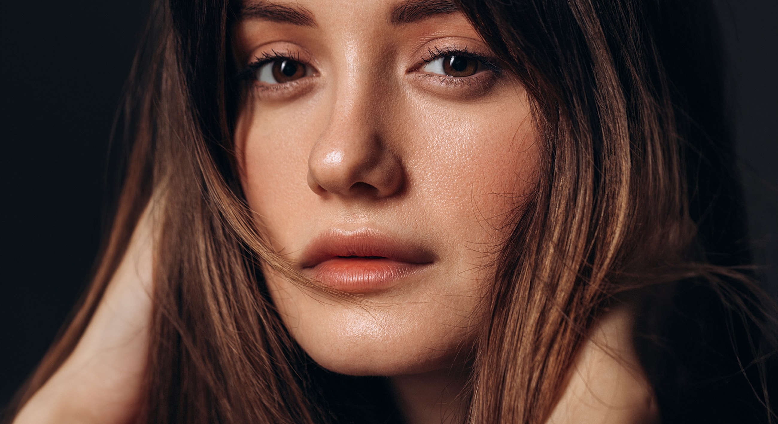 Close-up portrait of a woman with flowing hair.