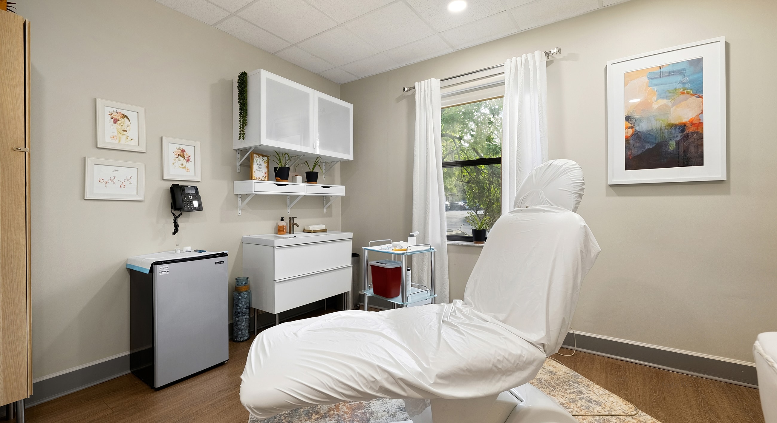 Clean aesthetic treatment room with medical equipment.