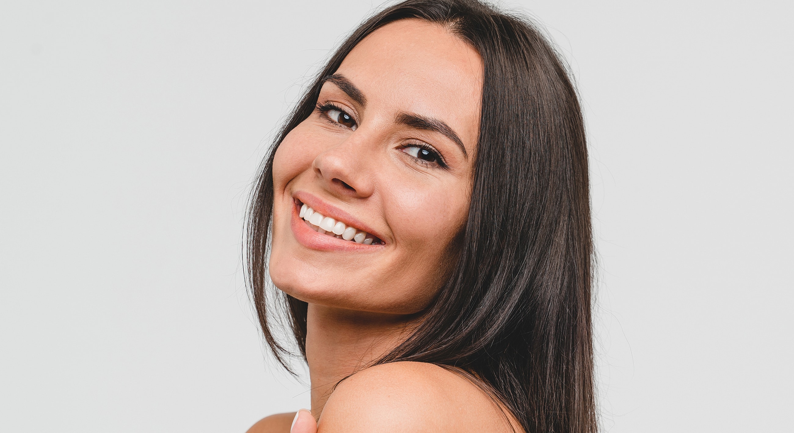 Smiling woman with long dark hair.